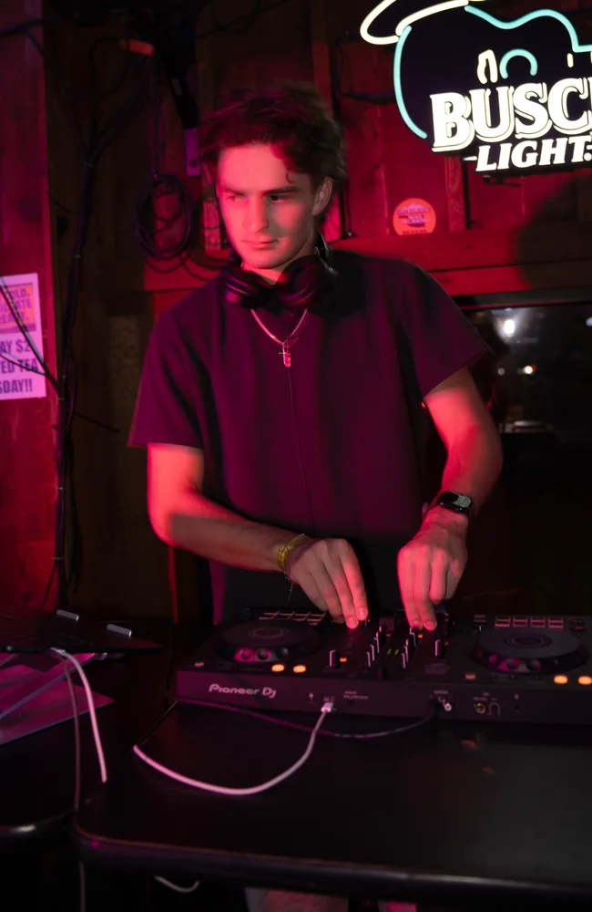 Lane Watt looking towards the room with his hands on the mixer