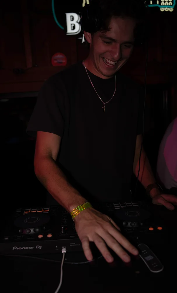 Lane Watt smiling as he plays with his hand on the mixer