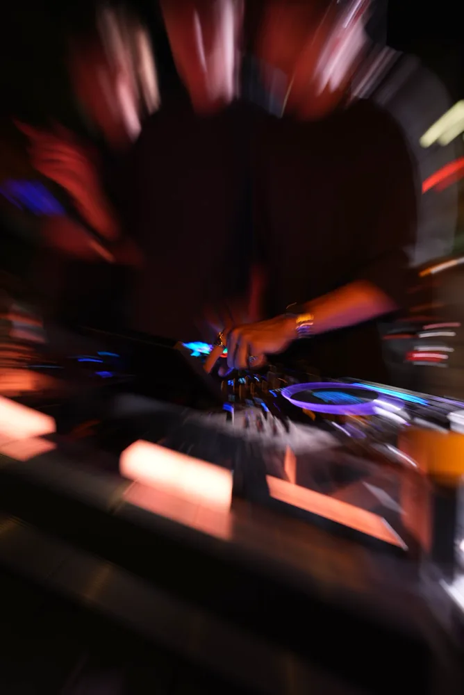 Radial motion trails around the decks and a performance silhouette