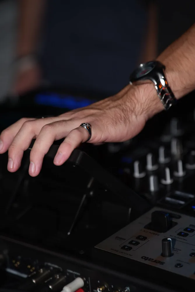 Close view of a hand adjusting mixer controls