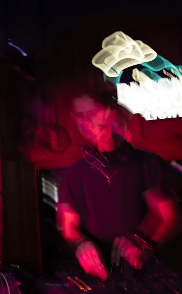 An expressive Lane Watt performance frame under red lighting