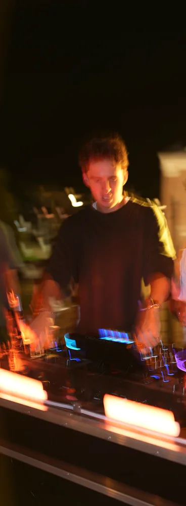 Lane Watt at the decks in warm amber light