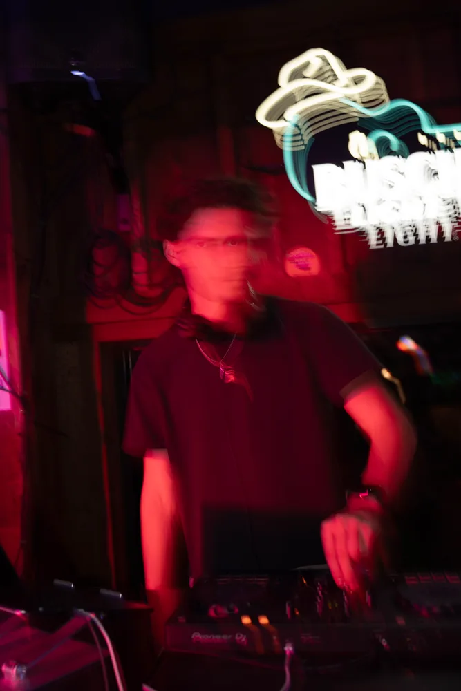 Lane Watt at the booth with red venue lighting
